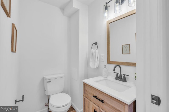 bathroom featuring toilet and vanity