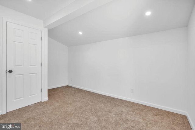 bonus room featuring light carpet and vaulted ceiling with beams