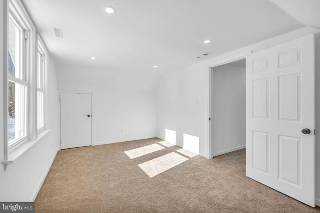 spare room with light carpet