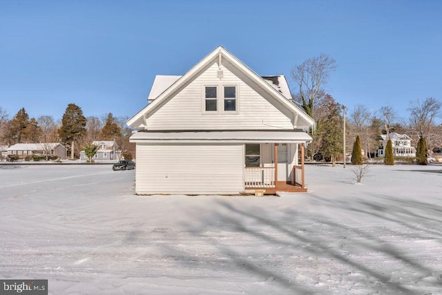 view of side of property with a porch