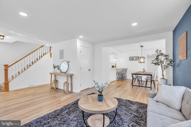 living room with an inviting chandelier and hardwood / wood-style floors