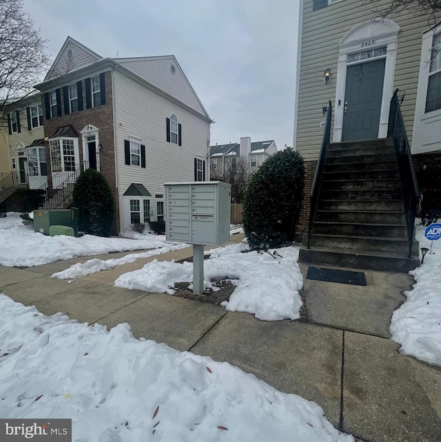 snow covered property with mail boxes