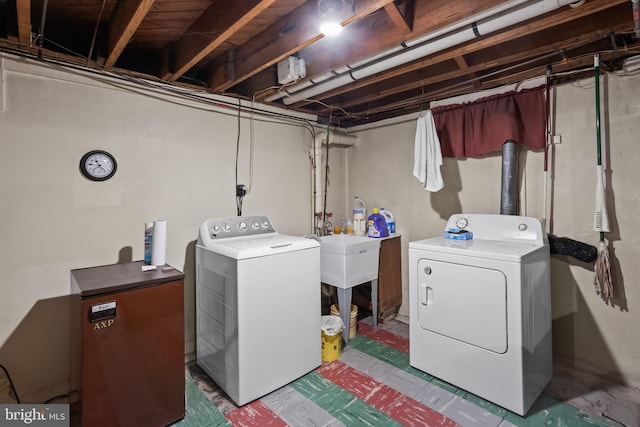 laundry room with washer and dryer and sink