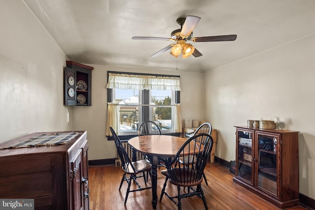 dining room with dark hardwood / wood-style flooring and ceiling fan