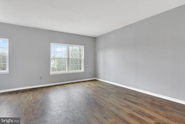 spare room with dark wood-type flooring