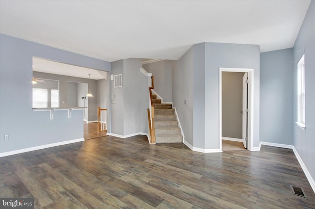 unfurnished living room featuring dark hardwood / wood-style floors