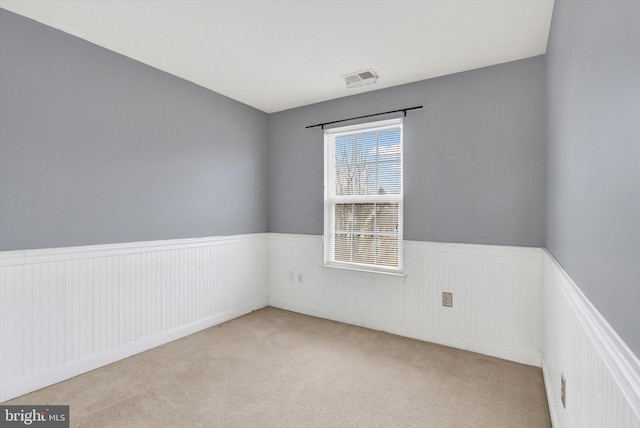 unfurnished room with light colored carpet