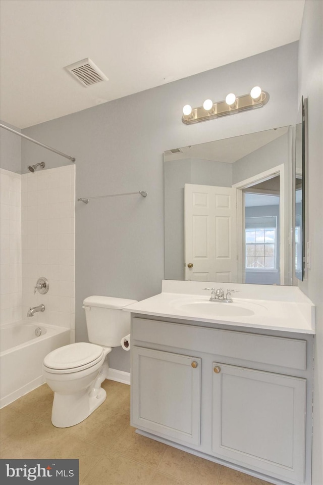 full bathroom featuring tiled shower / bath combo, vanity, tile patterned flooring, and toilet