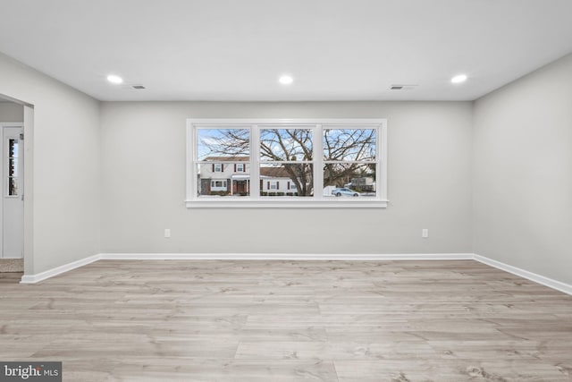 unfurnished room with light wood-type flooring