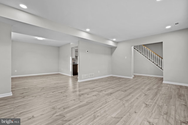 basement featuring light hardwood / wood-style flooring