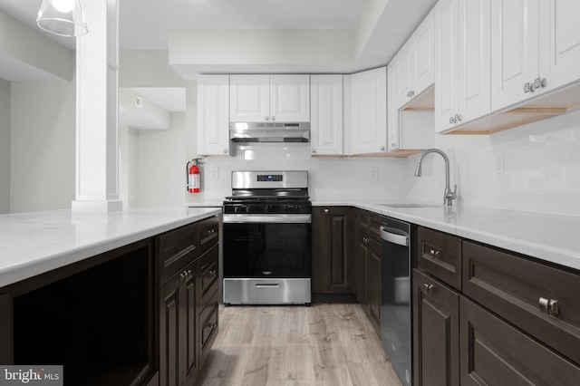 kitchen with backsplash, sink, white cabinetry, light hardwood / wood-style flooring, and appliances with stainless steel finishes