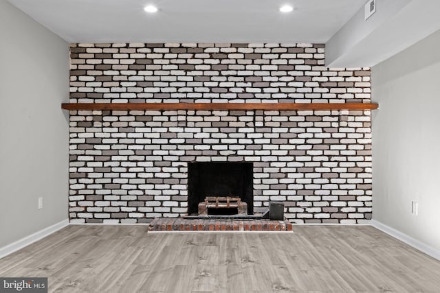 room details with hardwood / wood-style flooring and a brick fireplace