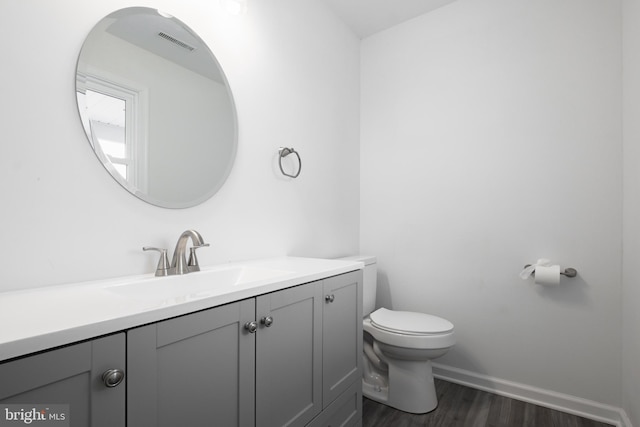 bathroom featuring hardwood / wood-style floors, toilet, and vanity