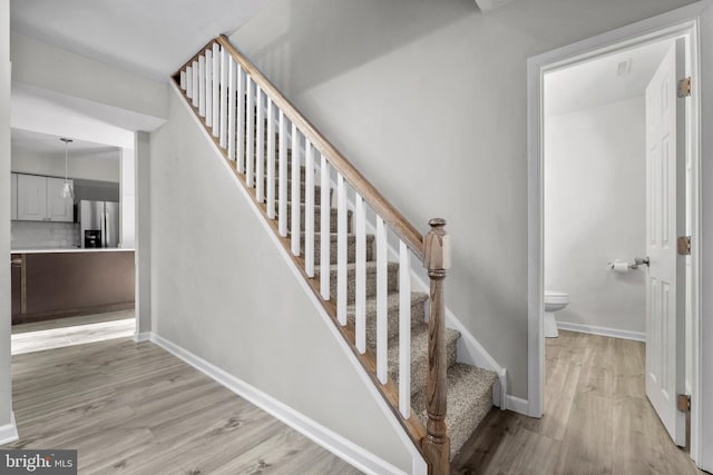 stairs with wood-type flooring