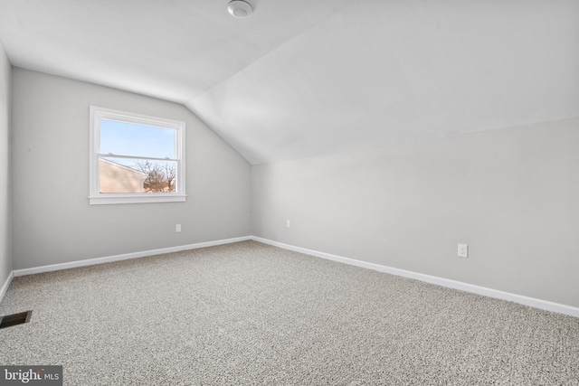 additional living space featuring lofted ceiling and carpet floors