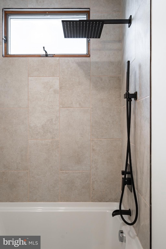 bathroom featuring tiled shower / bath and plenty of natural light