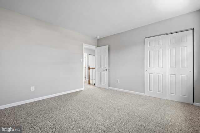 unfurnished bedroom featuring a closet and carpet flooring