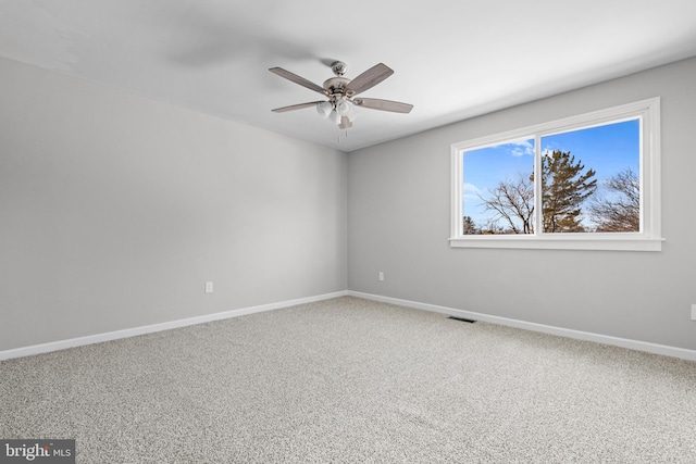 spare room featuring ceiling fan and carpet flooring