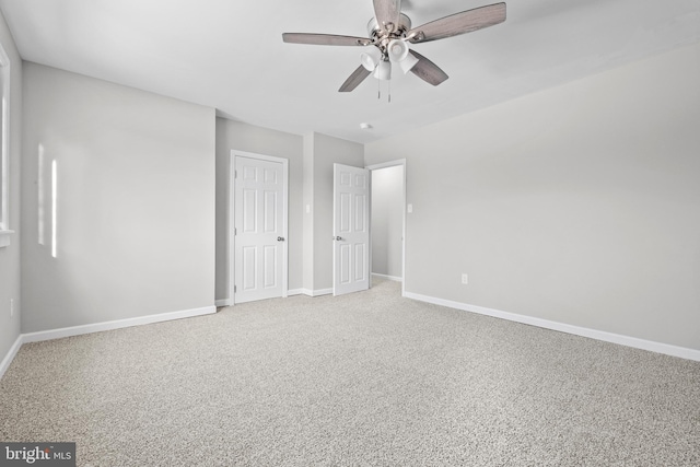 unfurnished bedroom with ceiling fan and carpet