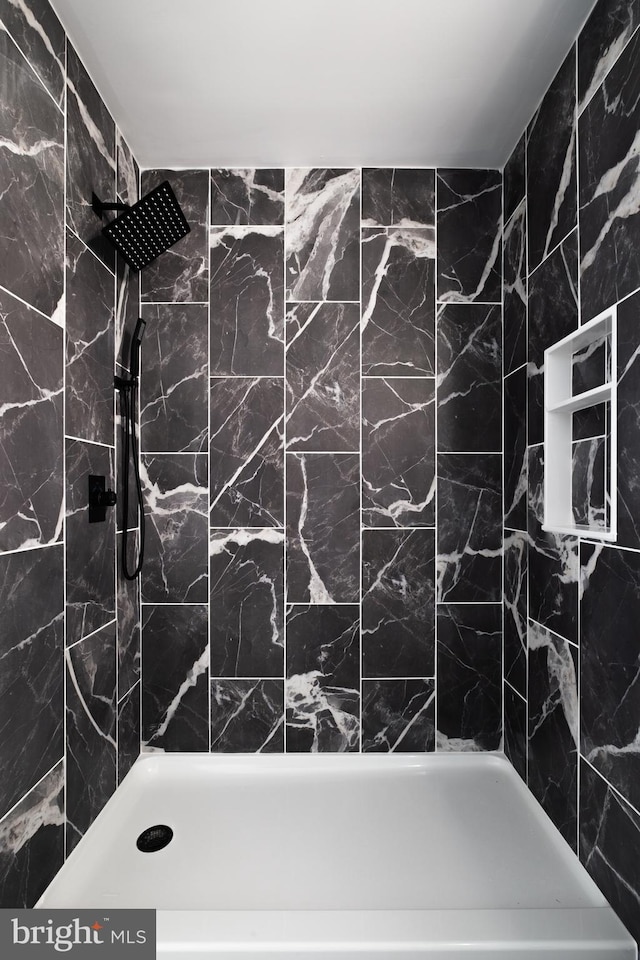 bathroom with a tile shower