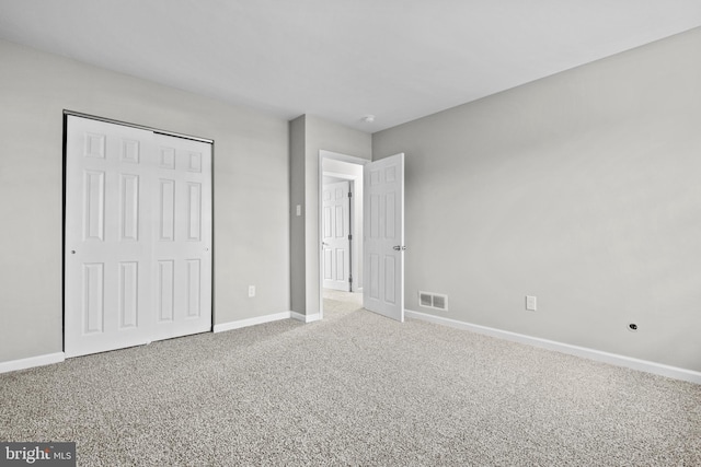 unfurnished bedroom featuring a closet and carpet floors