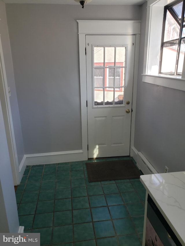 doorway to outside featuring dark tile patterned floors and a baseboard radiator