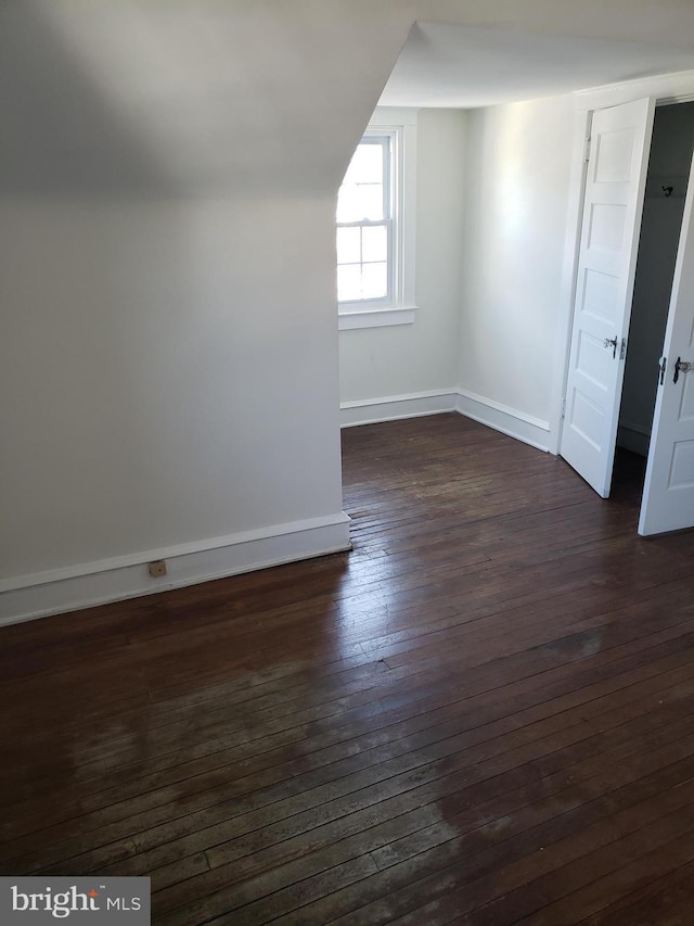 bonus room with dark hardwood / wood-style floors