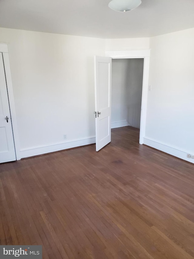 empty room featuring dark wood-type flooring