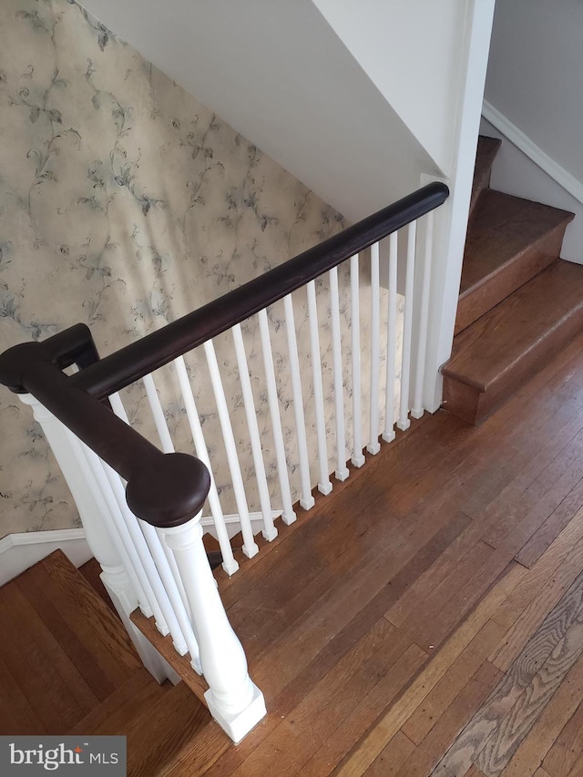 stairs featuring hardwood / wood-style flooring