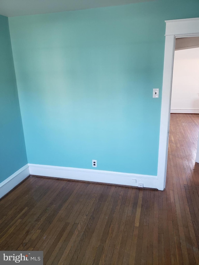 unfurnished room featuring dark hardwood / wood-style flooring