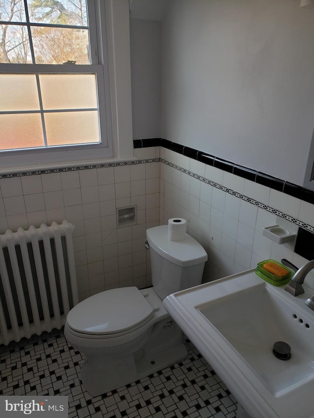 bathroom featuring tile patterned floors, plenty of natural light, and radiator heating unit