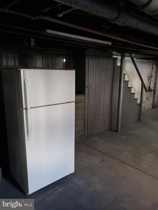 basement with white refrigerator