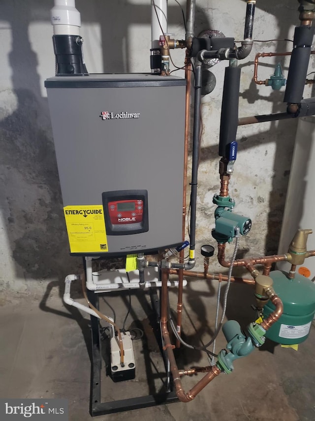 utility room featuring water heater