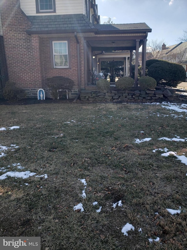 view of side of home featuring a lawn