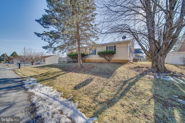 ranch-style home with a front lawn