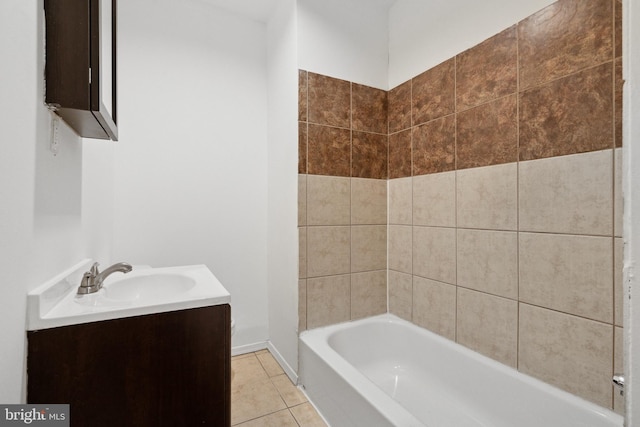 bathroom featuring tile patterned floors, vanity, and a bathing tub