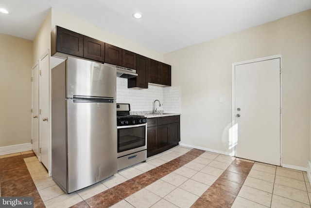 kitchen with appliances with stainless steel finishes, sink, backsplash, light tile patterned floors, and dark brown cabinets