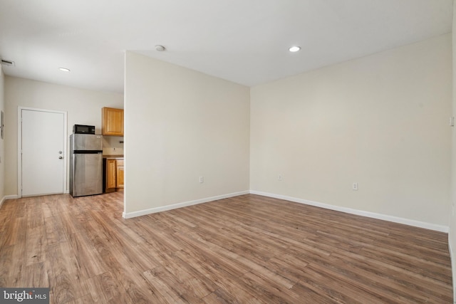 unfurnished living room featuring light hardwood / wood-style floors