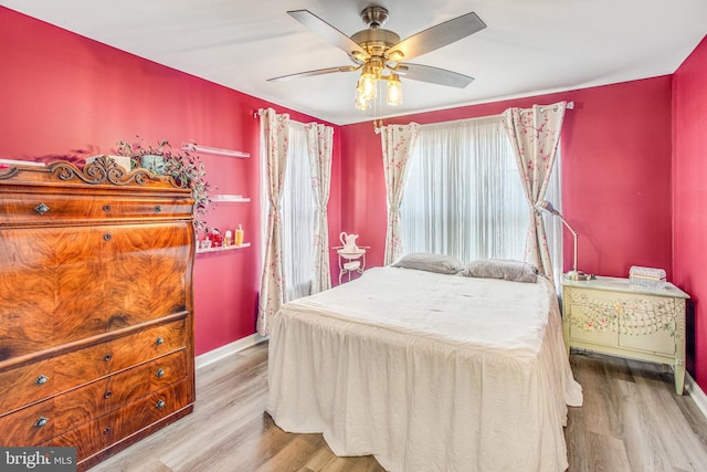 bedroom with ceiling fan and light wood-type flooring