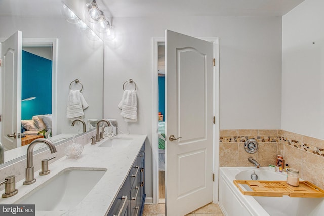 bathroom with vanity, a bath, and tile patterned flooring