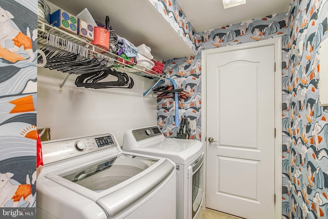 clothes washing area with light tile patterned flooring and washer and dryer