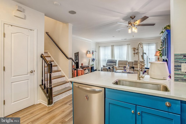 kitchen featuring blue cabinets, sink, light hardwood / wood-style flooring, ornamental molding, and dishwasher