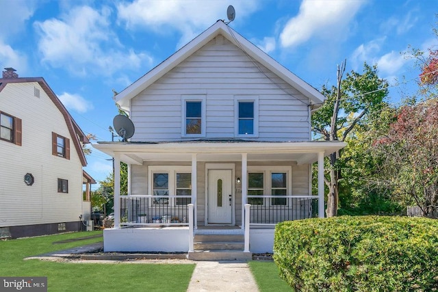 view of front of home with a porch and a front yard