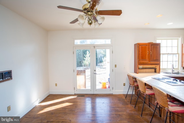 dining room featuring ceiling fan, dark hardwood / wood-style flooring, french doors, and sink