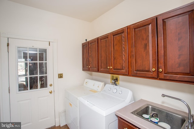 laundry area with cabinets, independent washer and dryer, and sink