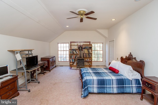 bedroom with ceiling fan, light colored carpet, and vaulted ceiling