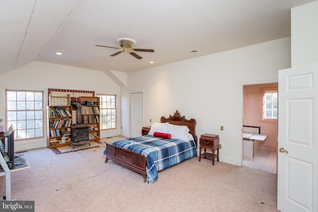 bedroom with ceiling fan, lofted ceiling, and carpet floors