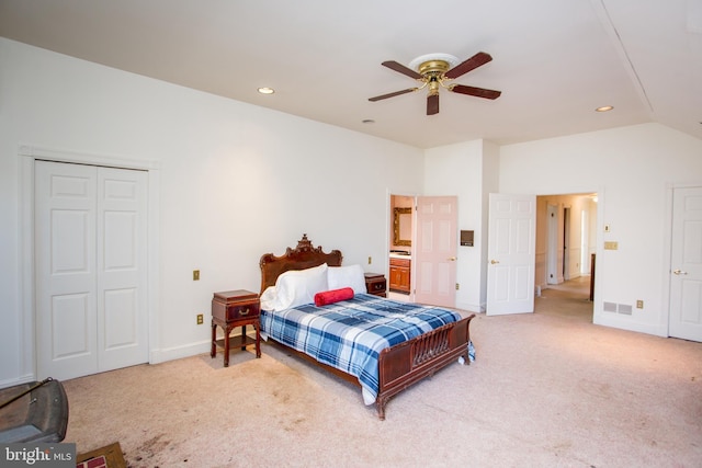 carpeted bedroom with lofted ceiling, ceiling fan, and a closet