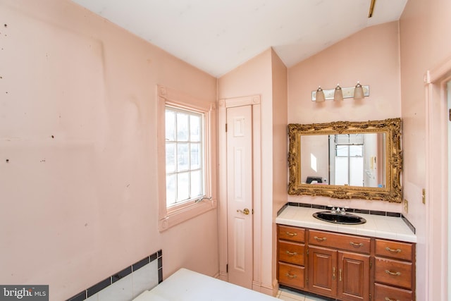 bathroom featuring vanity and vaulted ceiling