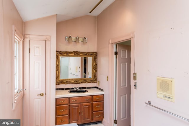 bathroom with vanity and vaulted ceiling